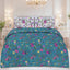 Floral bedding set on a bed in a bedroom with a chandelier.